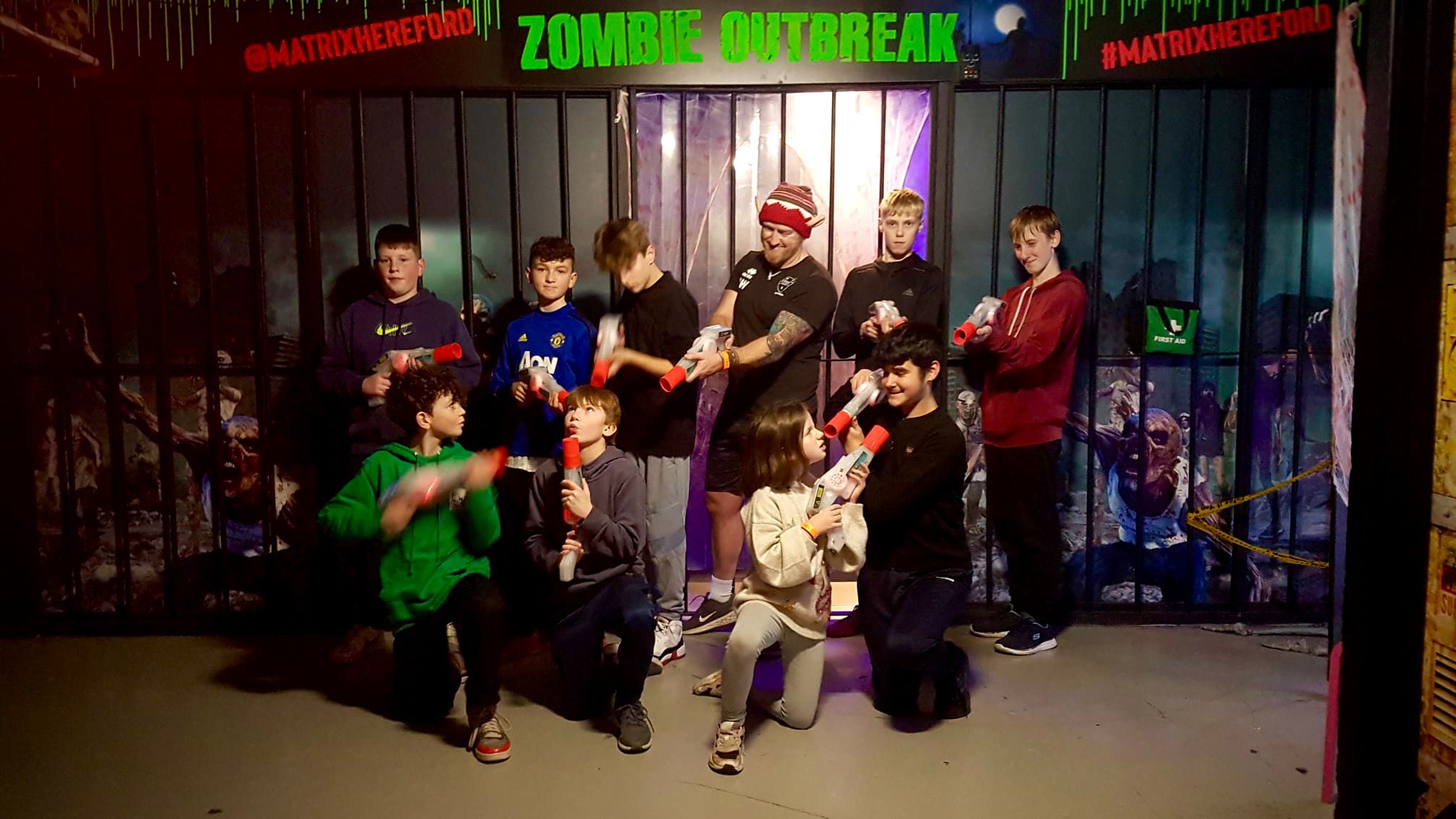 Group of kids and adults playing laser tag